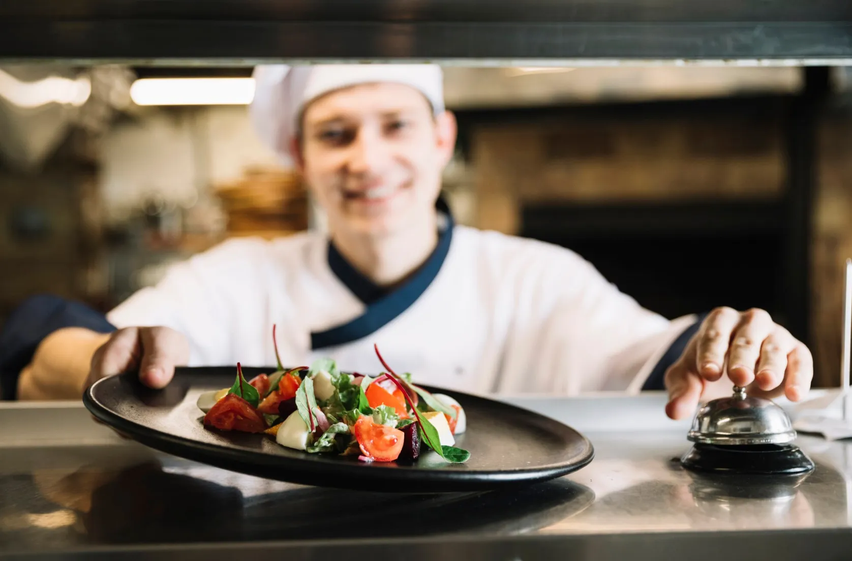 A chef meticulously plating a dish in a professional kitchen setting